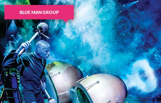 Blue Man Group with drums on stage